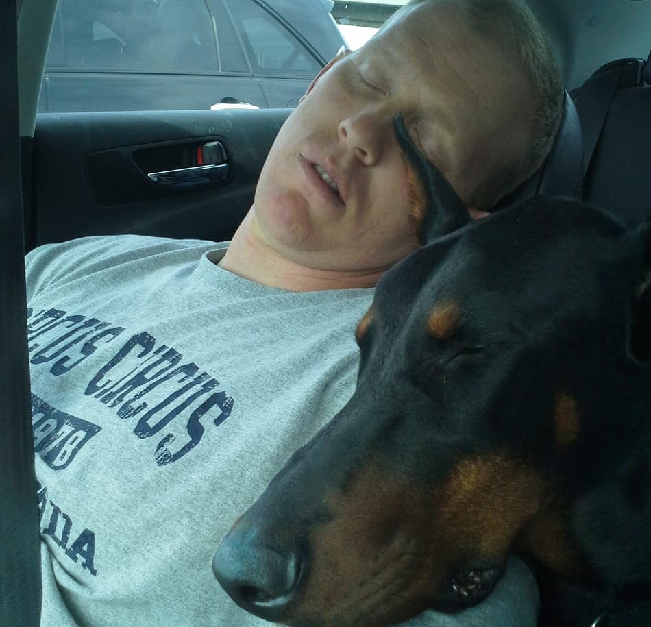 Me asleep in the car with my dobie Cooper.