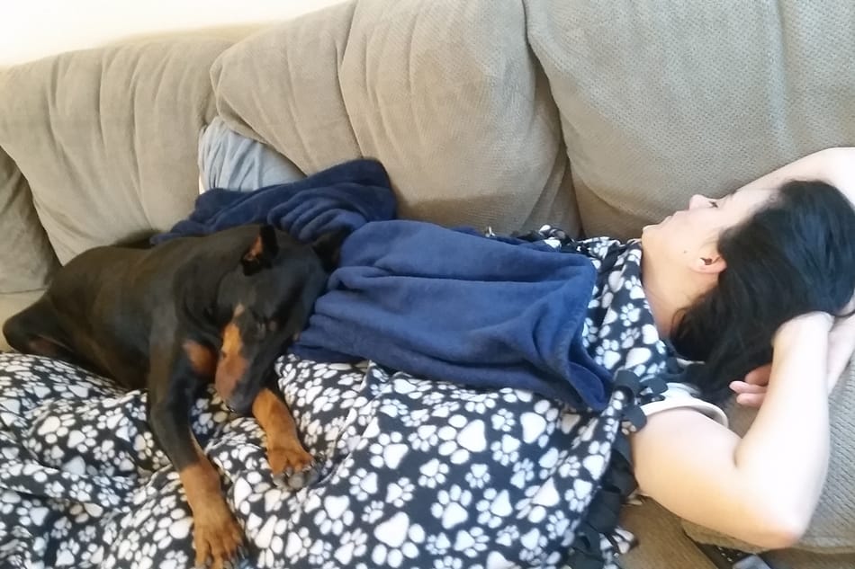 My Doberman sleeping on my wife.