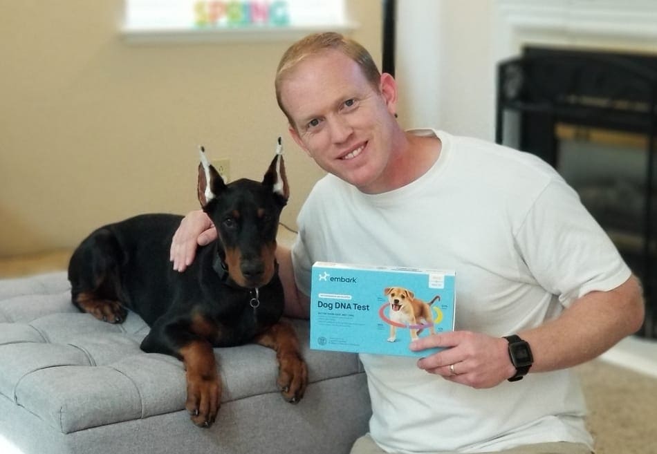 My Doberman Puppy Arlo and I holding my DNA test kit.